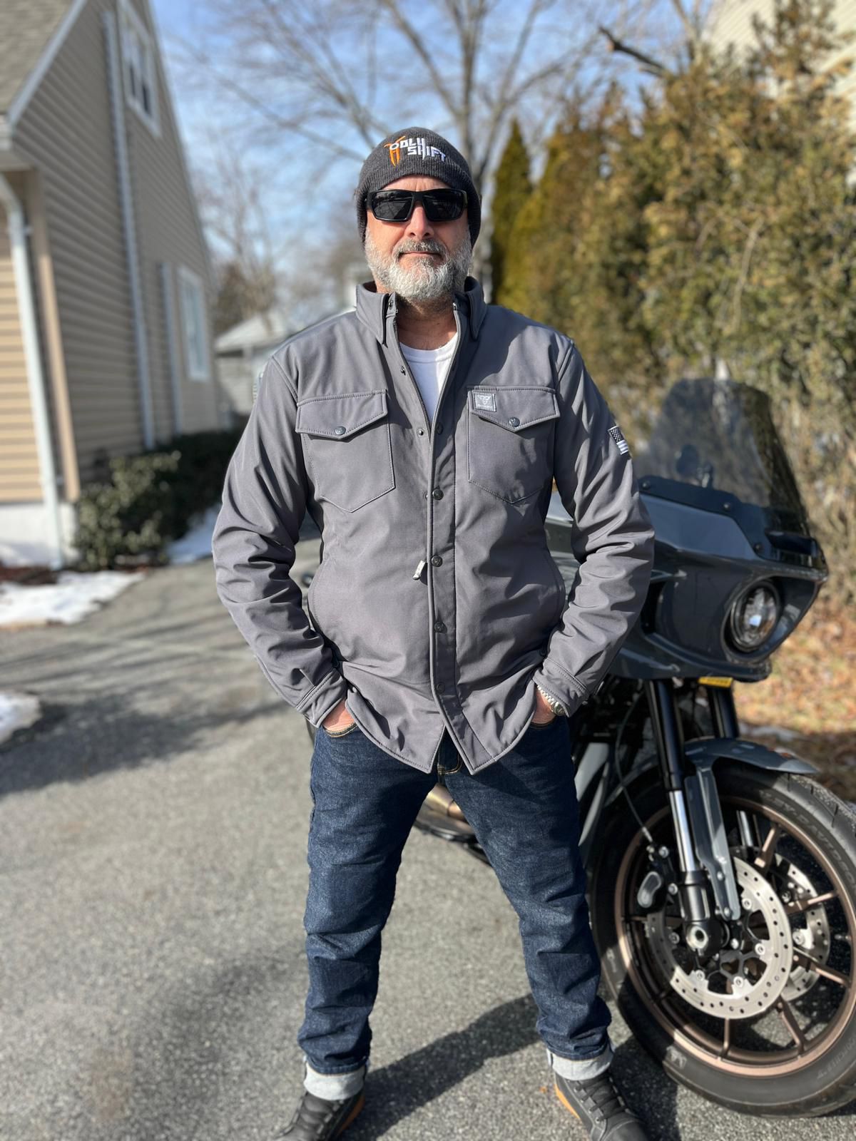 Rider-In-Protective-Gray-Jacket-On-Background-Of-Motorcycle