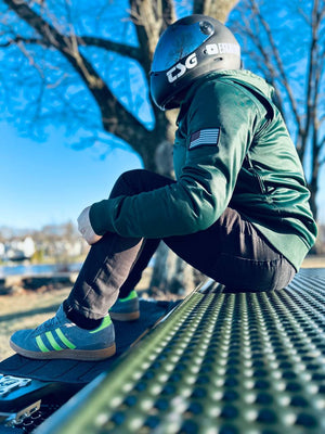 rider-sits-in-green-protective-hoodie