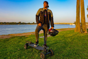 Rider-Stands-On-Skateboard-With-One-Foot-And-Holds-Helmet-In-His-Hand